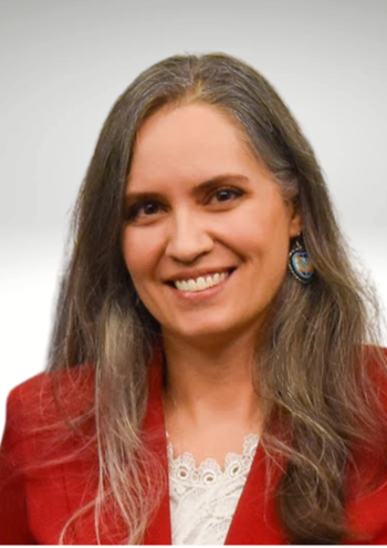 Headshot of Megan Dicken in front of a plain white background. Vignette effect around the edges.